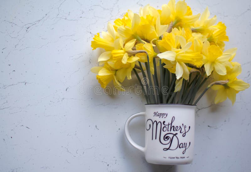 Mother `s day, flowers for mother, narcissists in the mug, inscription on mother `s mug day, mother `s day for all bright holiday