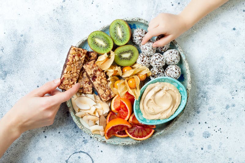 Mother sharing healthy vegan dessert snacks with toddler child. Concept of healthy sweets for children. royalty free stock photo Mother sharing healthy vegan dessert snacks with toddler child. Concept of healthy sweets for children. royalty free stock photo