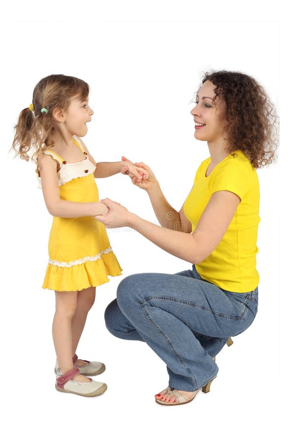 Mother sitting behind daughter and holding hands