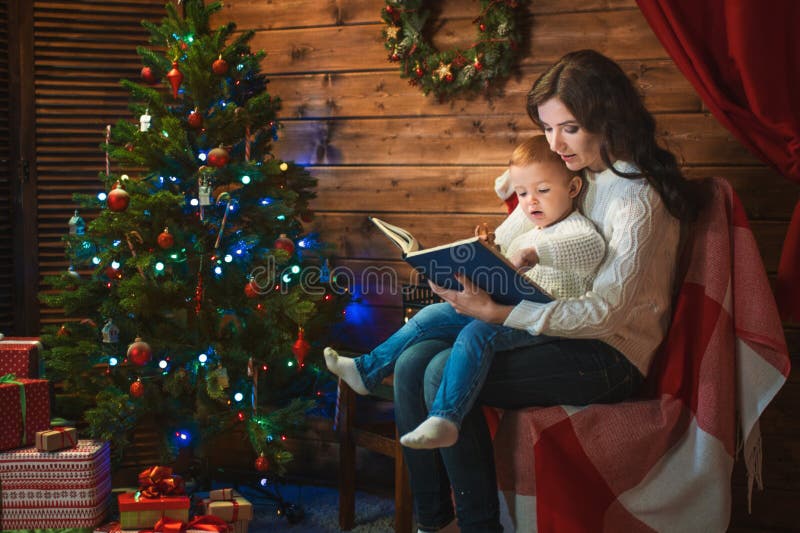 Mother and son celebrate Christmas in a decorated house with a C.