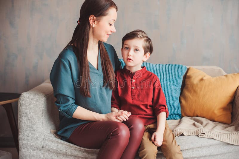 mother and son happy together at home, sitting at cozy couch. stock image mother and son happy together at home, sitting at cozy couch. stock image