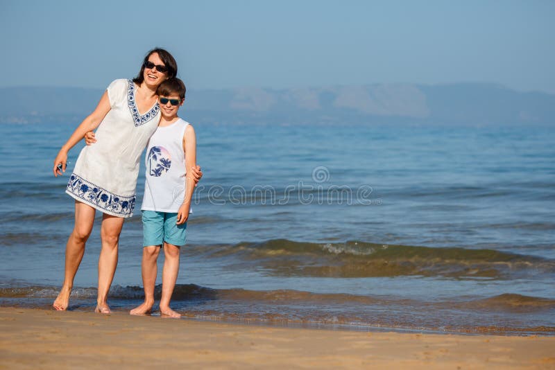 Mother and Son Having Fun on Beach during Summer Holiday Vacation Stock