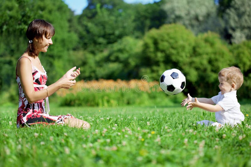 Mother and son playing ball in the park. stock photo Mother and son playing ball in the park. stock photo
