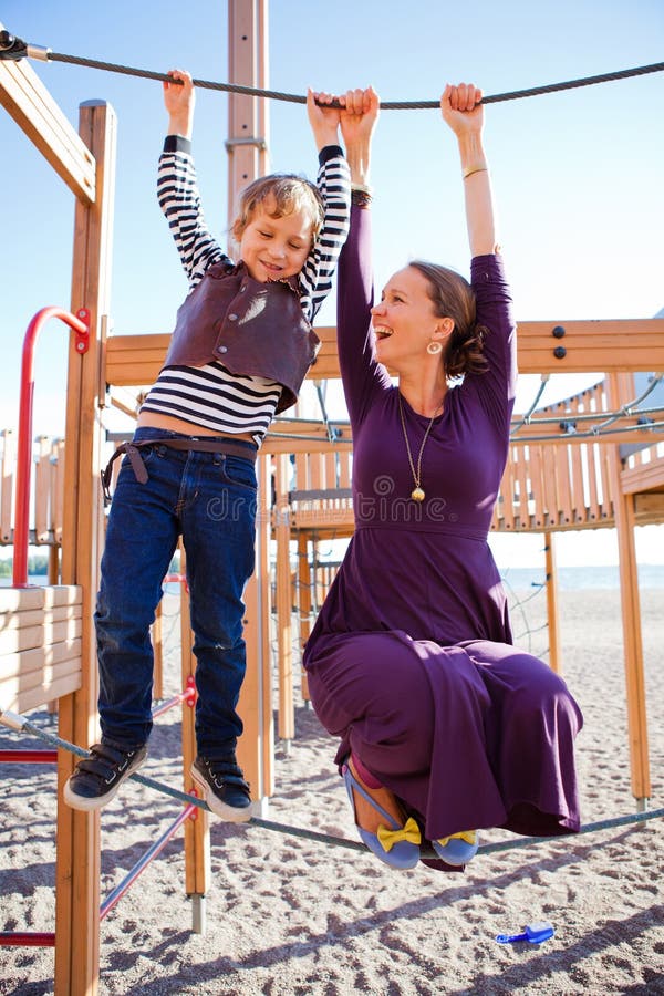 Mother and son playing at playground.