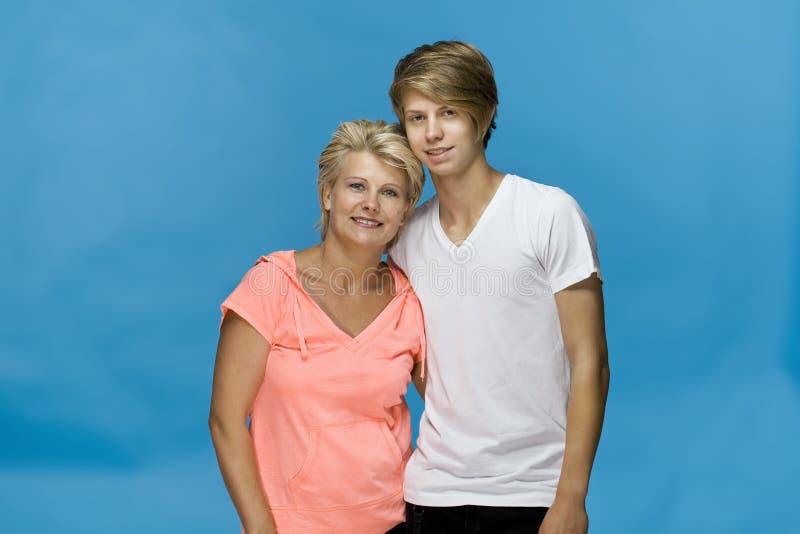 Mother and son portrait on blue background