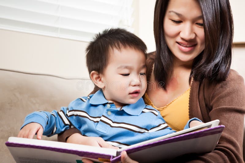Mother and son reading stock photos