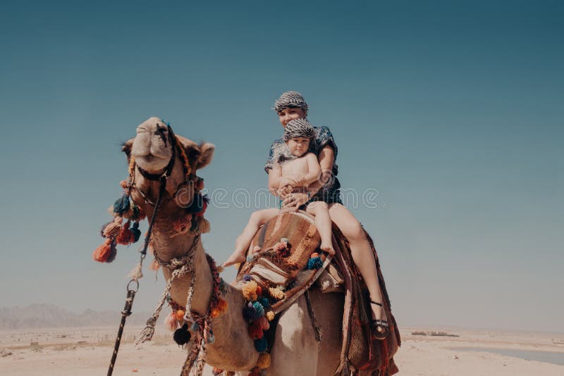 Mother with son ride a camel. Egypt, Hurghada