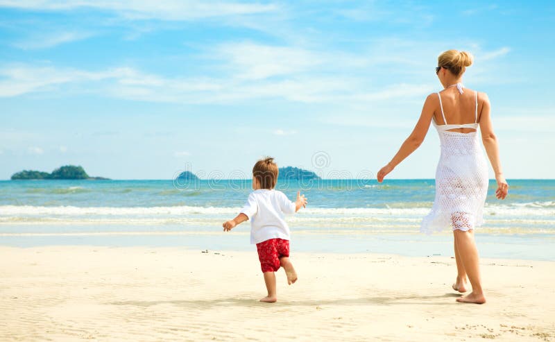 Mother and son running on beach