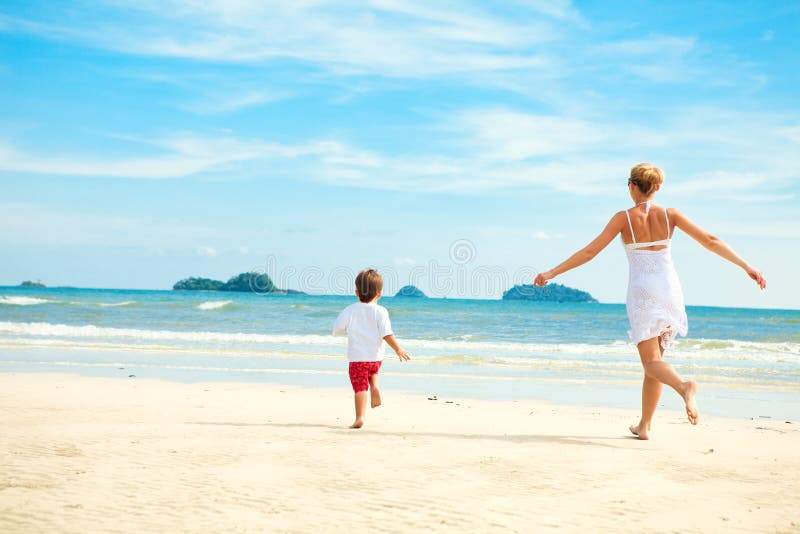 Mother and son running on beach