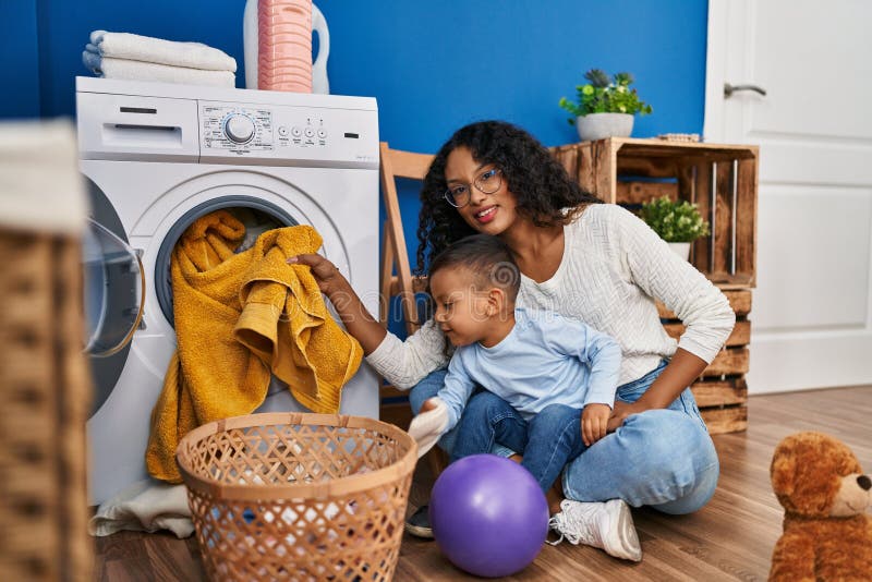 Mother and Son Smiling Confident Washing Clothes at Laundry Room Stock ...