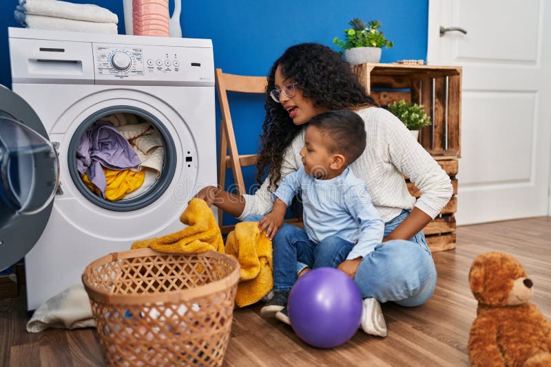 Mother and Son Smiling Confident Washing Clothes at Laundry Room Stock ...