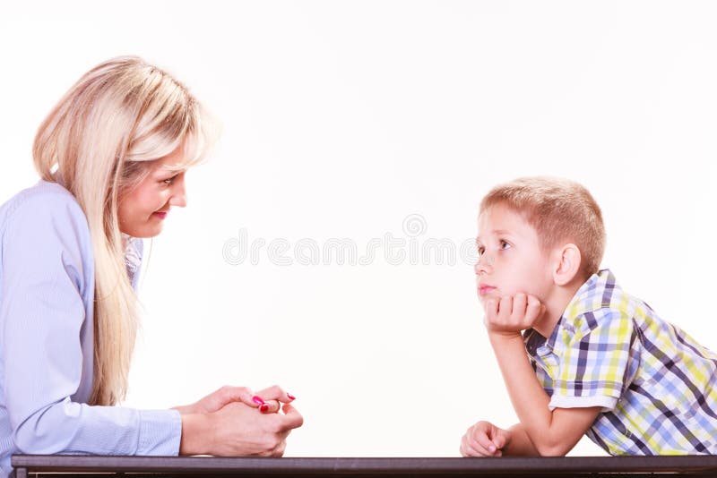 Mother and son talk and argue sit at table. royalty free stock photography Mother and son talk and argue sit at table. royalty free stock photography