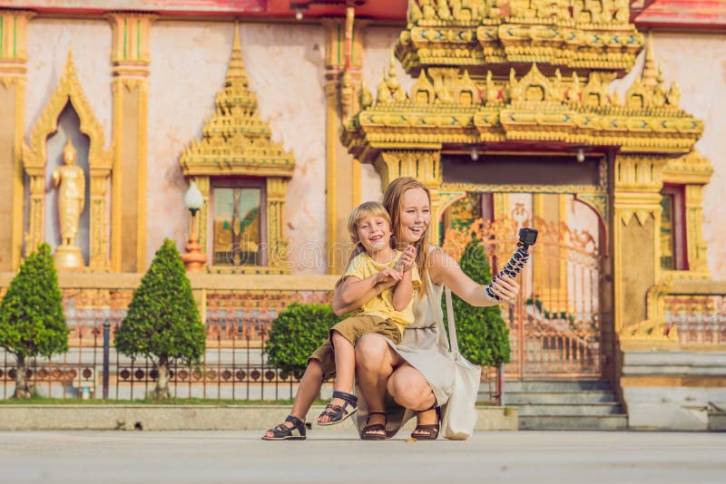 Mother and son tourists look at Wat Chalong is the most important temple of Phuket royalty free stock images Mother and son tourists look at Wat Chalong is the most important temple of Phuket royalty free stock images