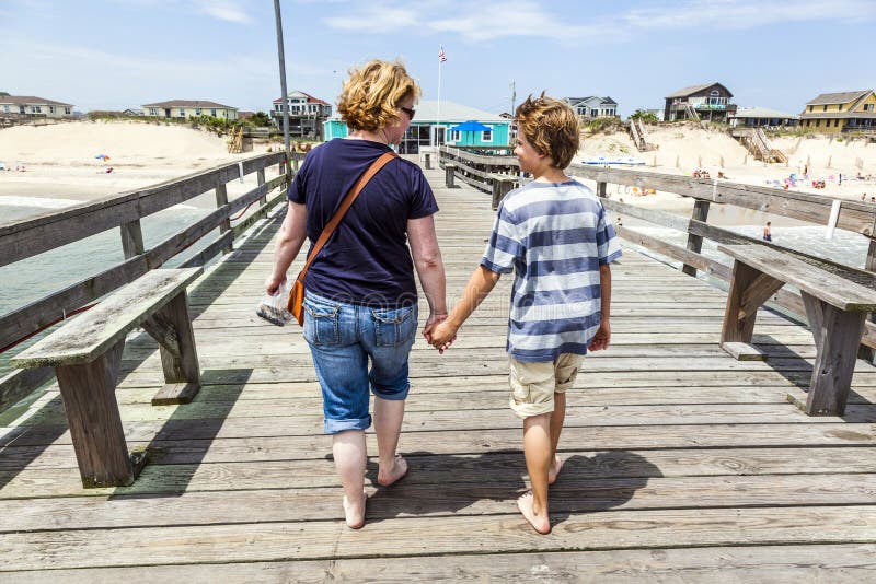 Mother and son walking hand in hand