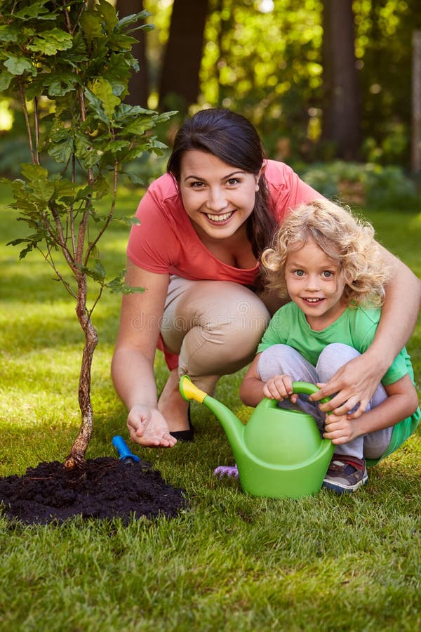 Mother and Son Watering Tree Stock Image - Image of happiness, watering ...