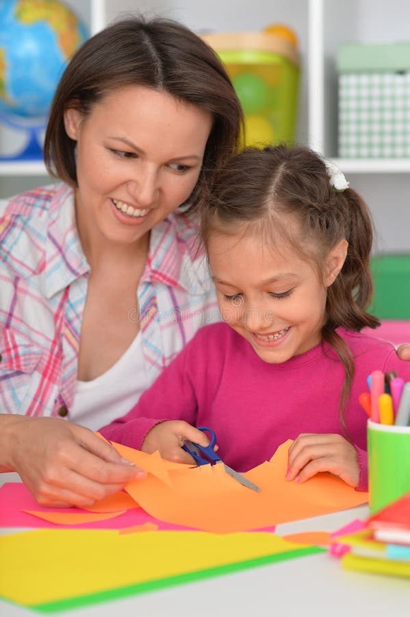 Mother teaches her cute daughter to do craft items