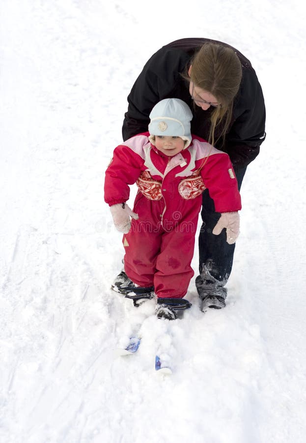 Mother teaching child to ski royalty free stock photo