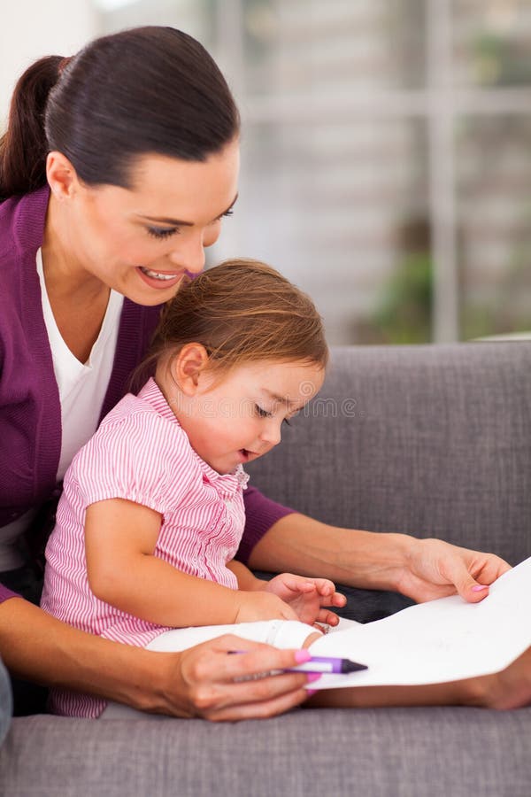 Mother teaching daughter stock image
