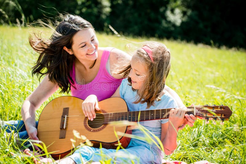 Mother Teaching Daughter Playing Guitar Stock Image - Image of ...