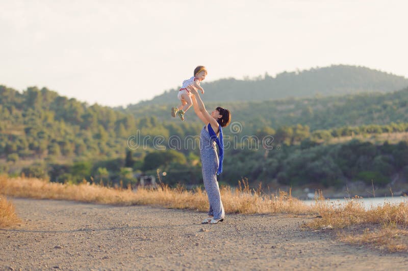Mother Throwing Baby up stock image. Image of fashion 42970329