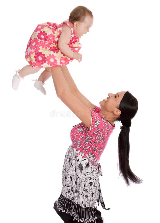 A mother throws his infant child into the air stock photos