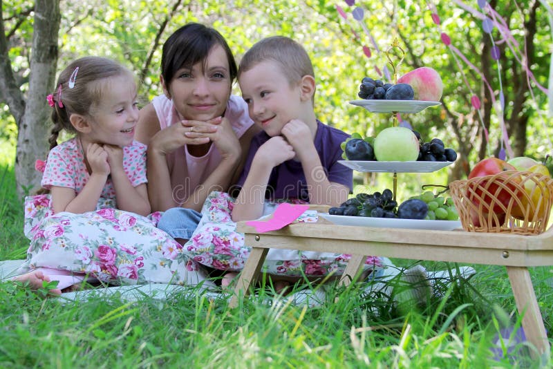 Mother with two children having summer picnic