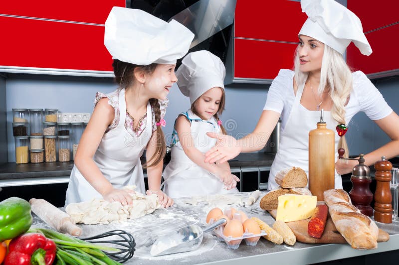 Mother and two daughters in the kitchen