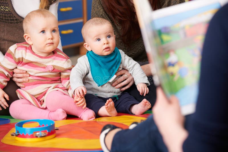 Mothers With Children At Baby Group Listening To Story