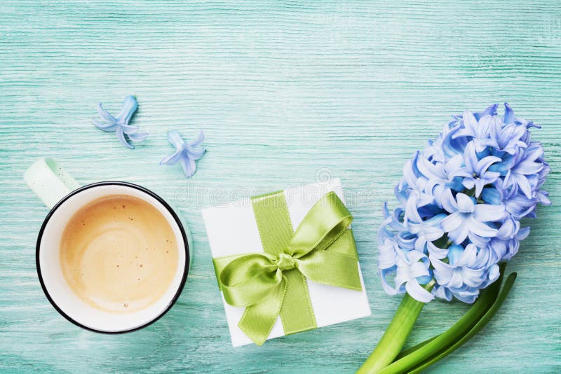 Mothers Day spring greeting background with flowers, gift or present box and cup of coffee top view. Morning breakfast for holiday stock photos Mothers Day spring greeting background with flowers, gift or present box and cup of coffee top view. Morning breakfast for holiday stock photos