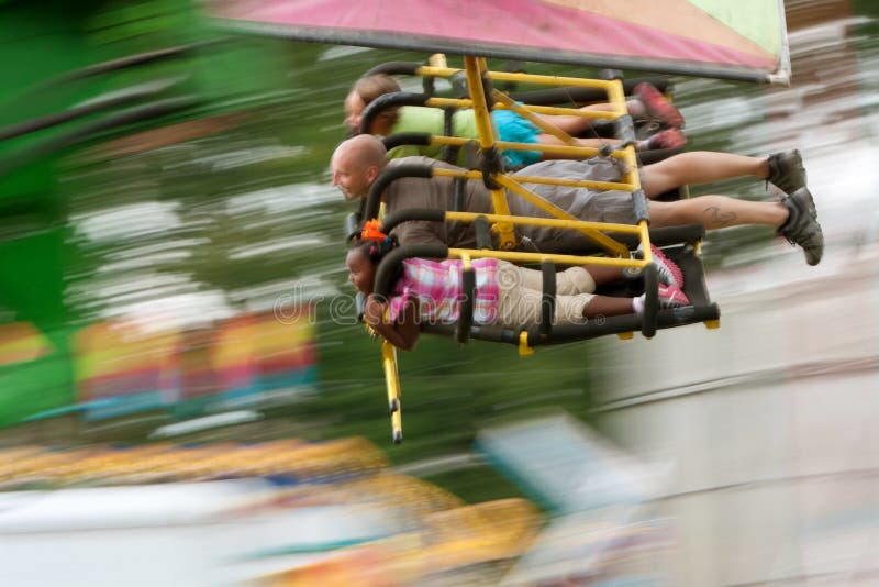 Teens On A Flying Carnival Ride Motion Blur Editorial