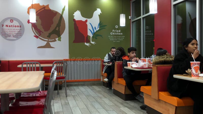 Motion of people enjoy a meal inside Popeyes chicken restaurant