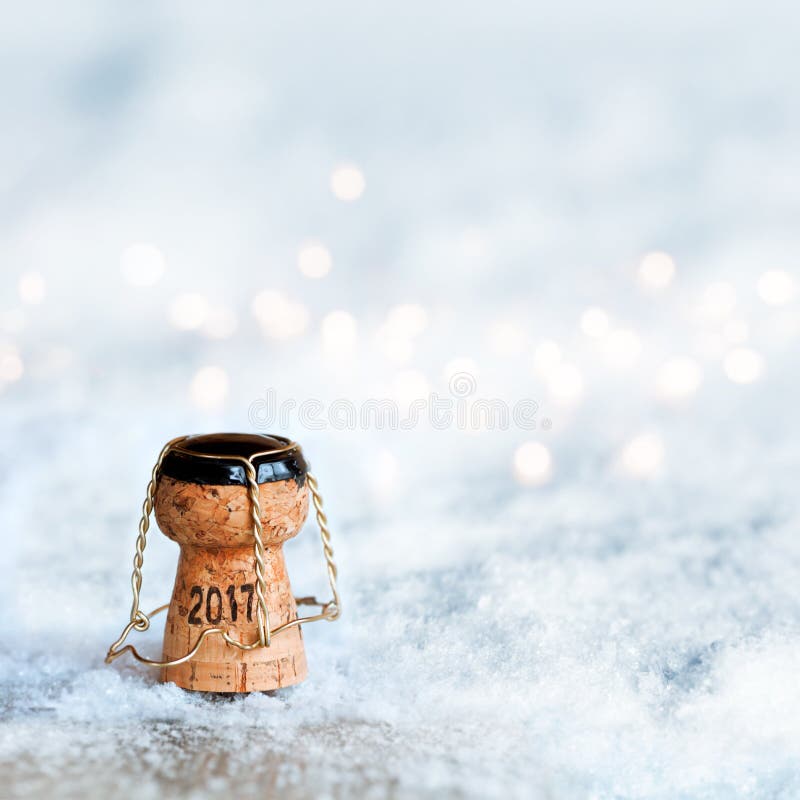 New Year motif 2017 with a champagne cork in a snow landscape. New Year motif 2017 with a champagne cork in a snow landscape