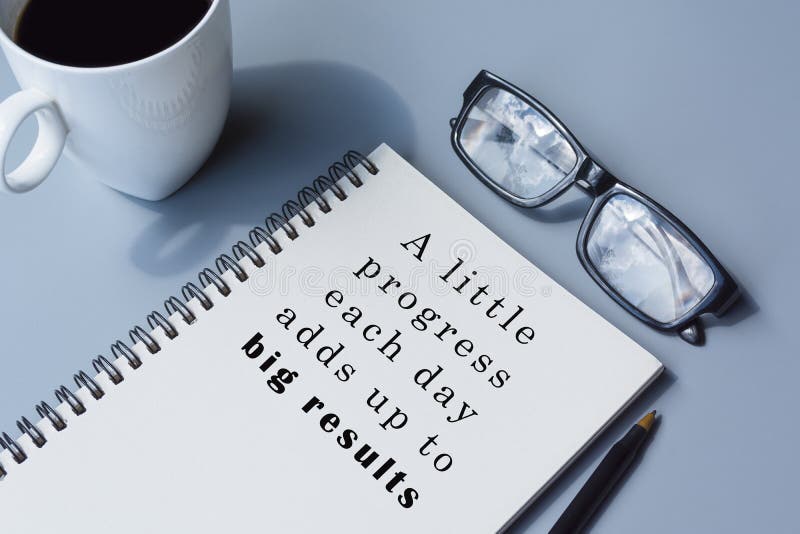 Motivational and inspirational quote on notepad with coffee pen and glasses stock photo image 