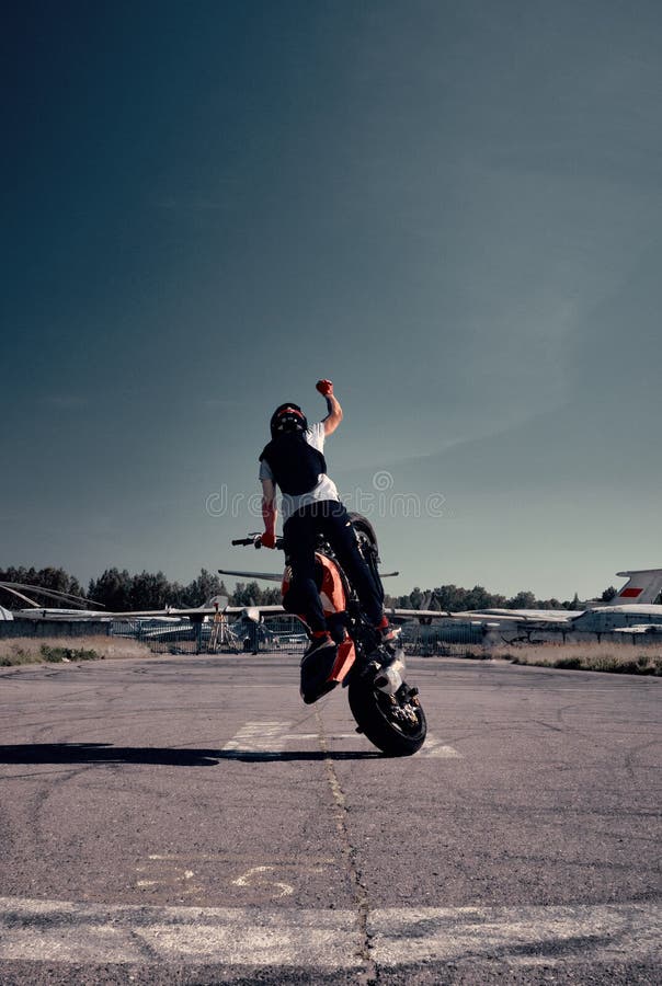 Free Photo  Moto rider making a stunt on his motorbike biker