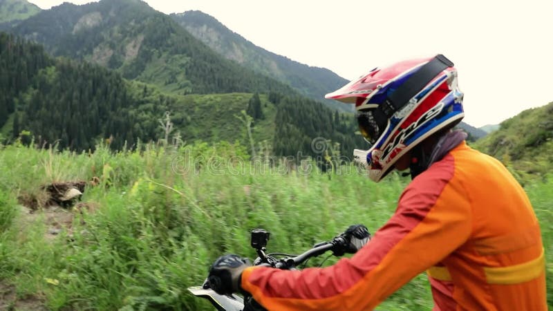 Motociclista andando em trilha na floresta verde