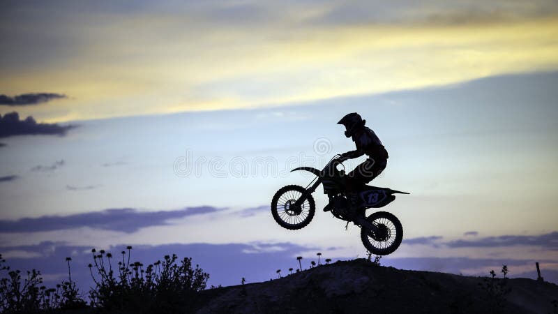 Motocross Rider Performing High Jump At Sunset Stock Photo - Download Image  Now - Motocross, Motorcycle, Jumping - iStock