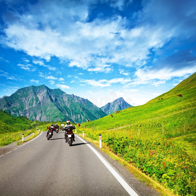 Motocyclists on countryside in mountains