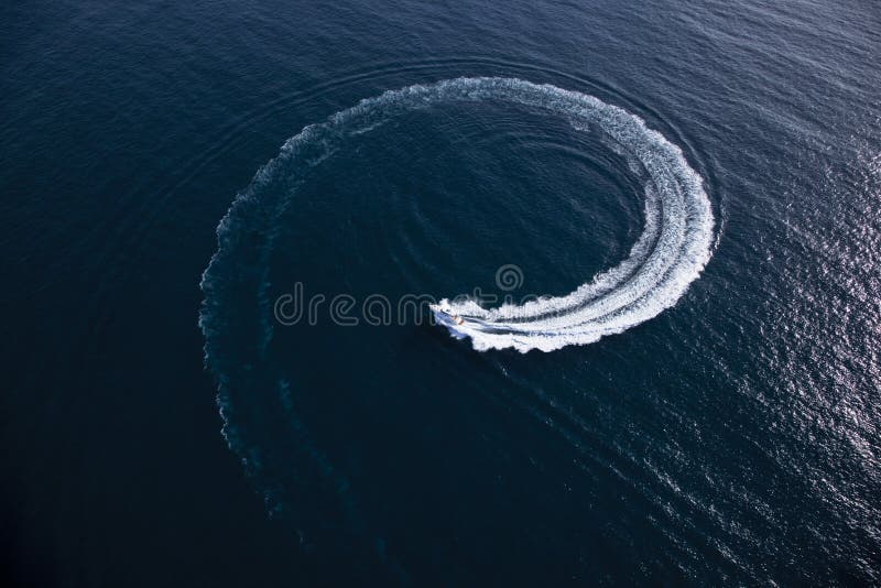 Motor boat making a turn in form of a swirl