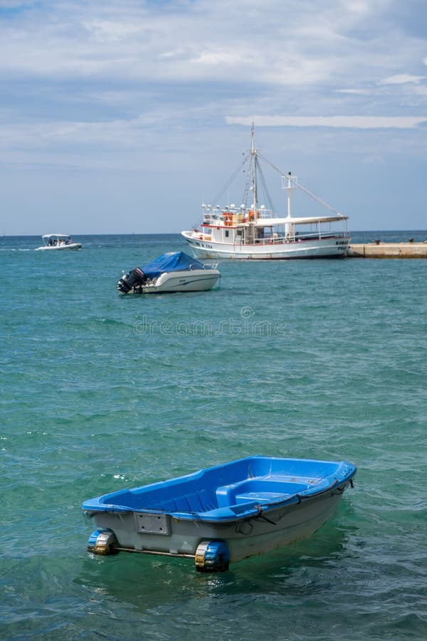 Motor Boat and Small Ships on the Water by a Harbor Editorial Stock