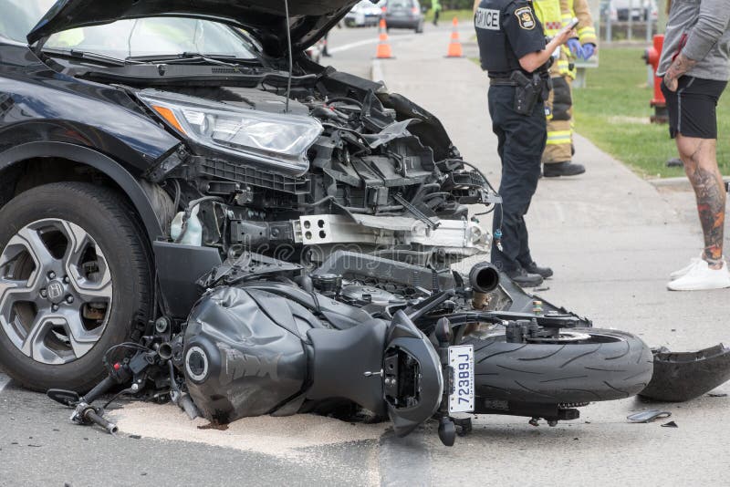 Motorcycle accident, bike stuck under car

Editorial Use only