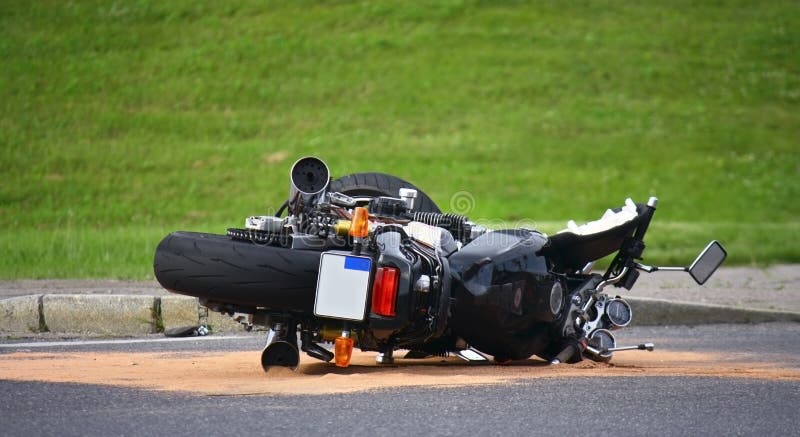 Motorcycle accident on the street with green bacground