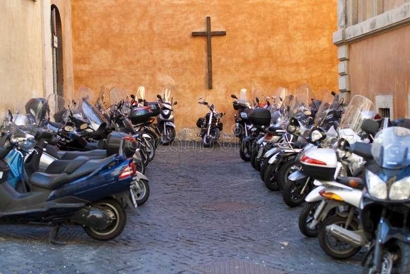 Lot's of motorcycle parked near church with cross on the wall. Lot's of motorcycle parked near church with cross on the wall