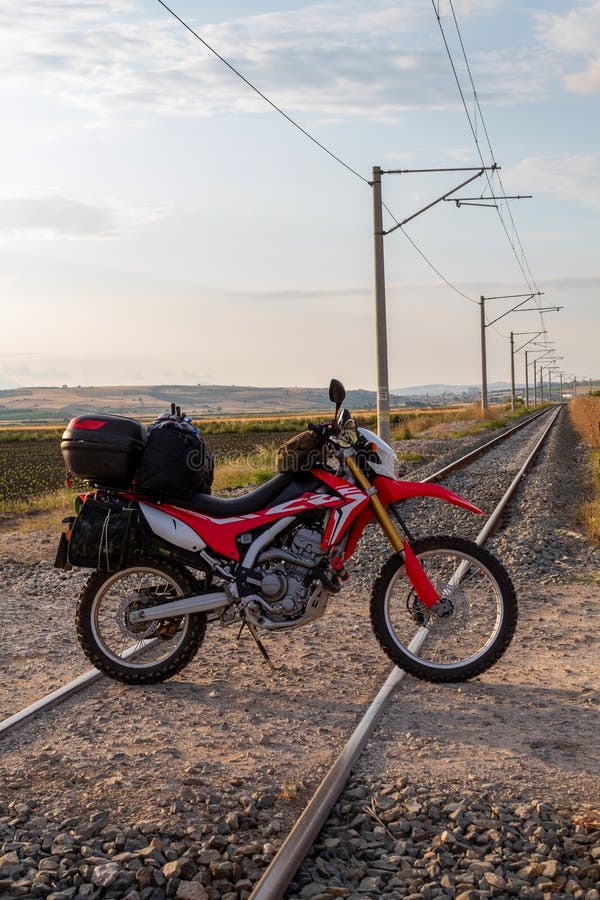 Motorcycle Loaded on the Bag, on Train Tracks Editorial Photography