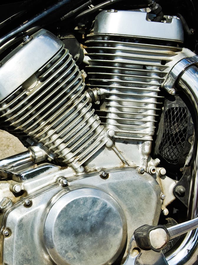 Motorcycle motors - chrome details mechanism and exhaust pipes. Powerful V-twin engine with a radiator at the motor