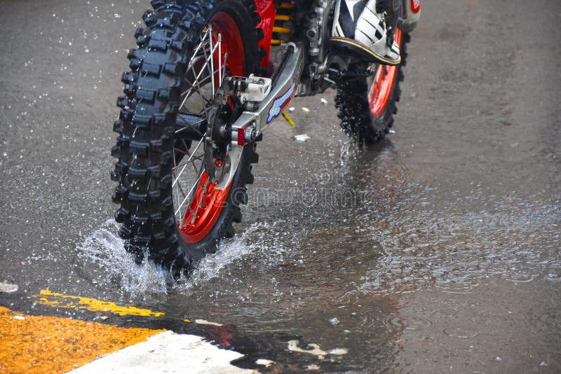The Motorcycle Rides on the Water with a Spray Stock Image - Image of
