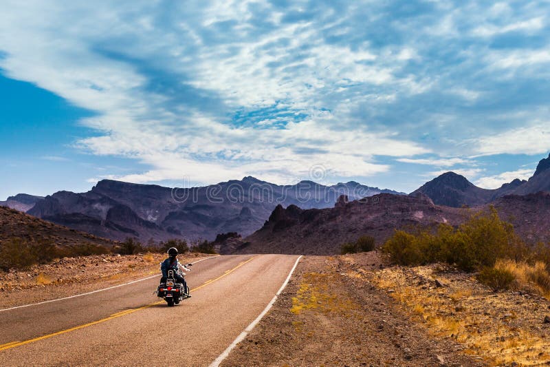 Motorbiker driving on the Highway on legendary Route 66 to Oatman, Arizona. Motorbiker driving on the Highway on legendary Route 66 to Oatman, Arizona.