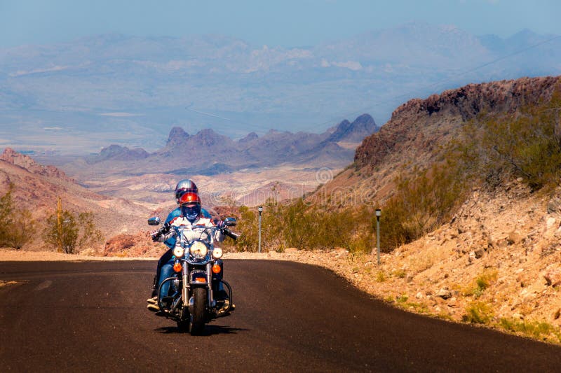 Biker driving on the Highway on legendary Route 66 to Oatman, Arizona. Biker driving on the Highway on legendary Route 66 to Oatman, Arizona.