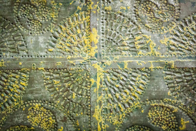 Various motifs hammered into gray-green metal with yellow spatters. Various motifs hammered into gray-green metal with yellow spatters