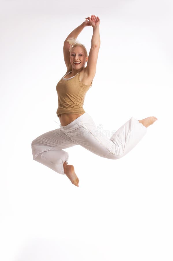 Young woman jumping with the arms lifted up. Young woman jumping with the arms lifted up