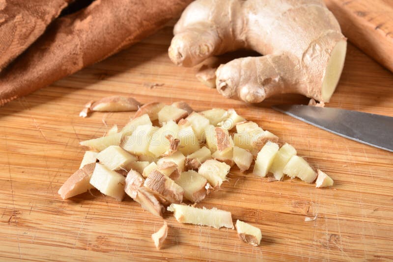 Chopped Ginger Root Cutting Block And Knife Top View Stock Photo